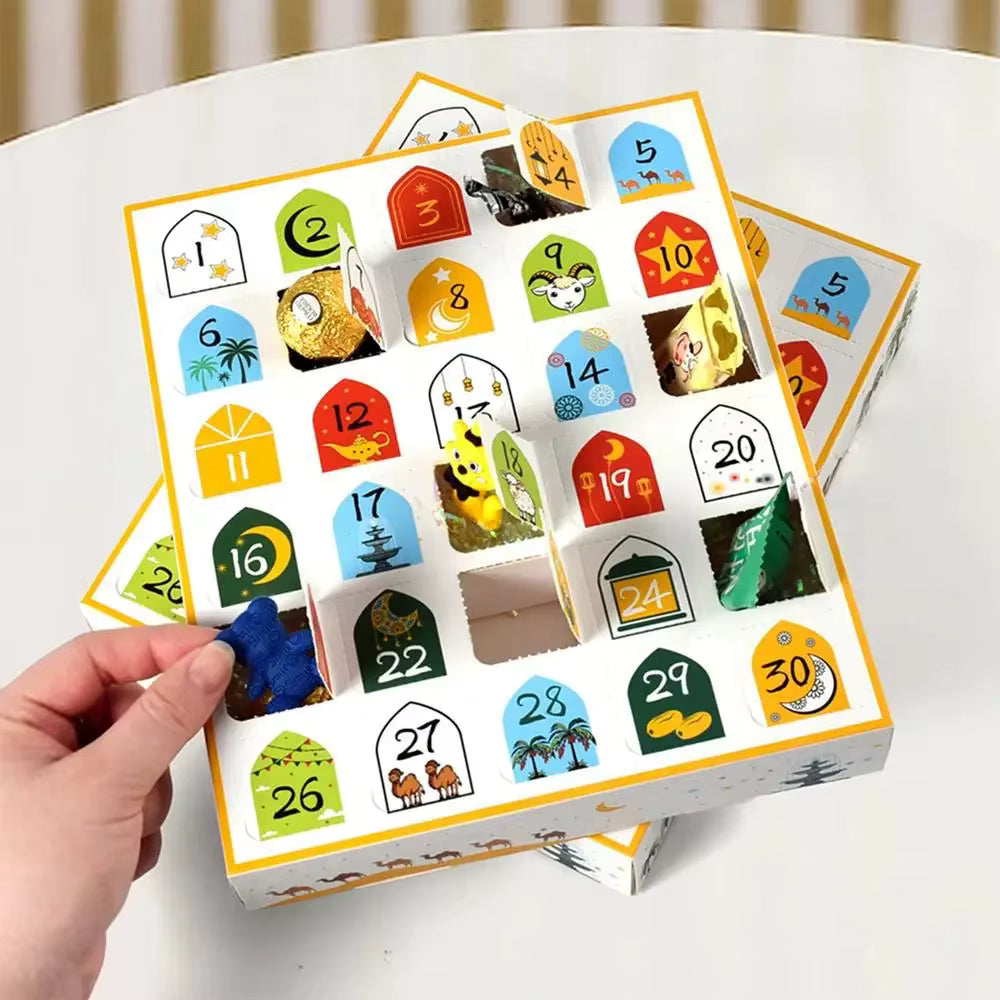 Load video: This video shows a Ramadan advent calendar box placed on a flat surface. The box is decorative, colorful, and designed for counting down the days of Ramadan. The camera slowly pans across the box, highlighting its details, compartments, and festive design. The box includes small numbered sections representing each day of Ramadan. The video focuses on the overall appearance of the box rather than opening it. There is no spoken audio, only background music. The atmosphere is festive, and the video emphasizes the beauty and design of the advent calendar.